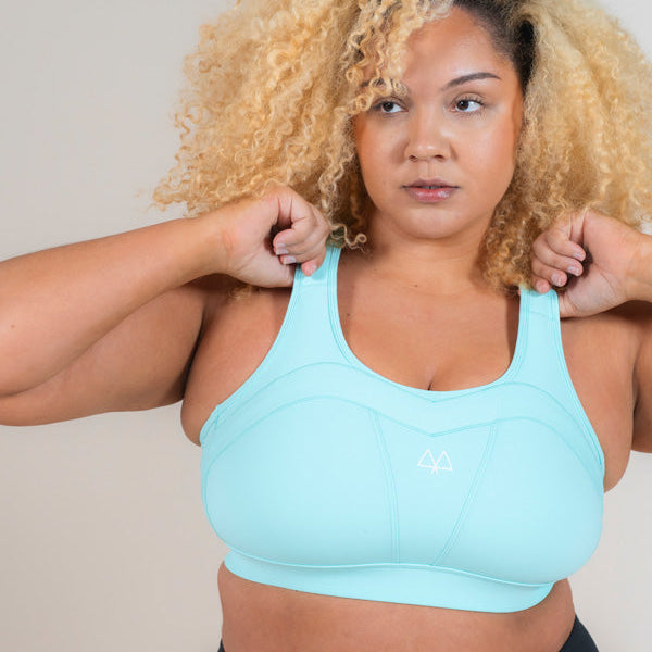 Woman standing wearing MAAREE Empower Sports Bra in Spearmint Green colour